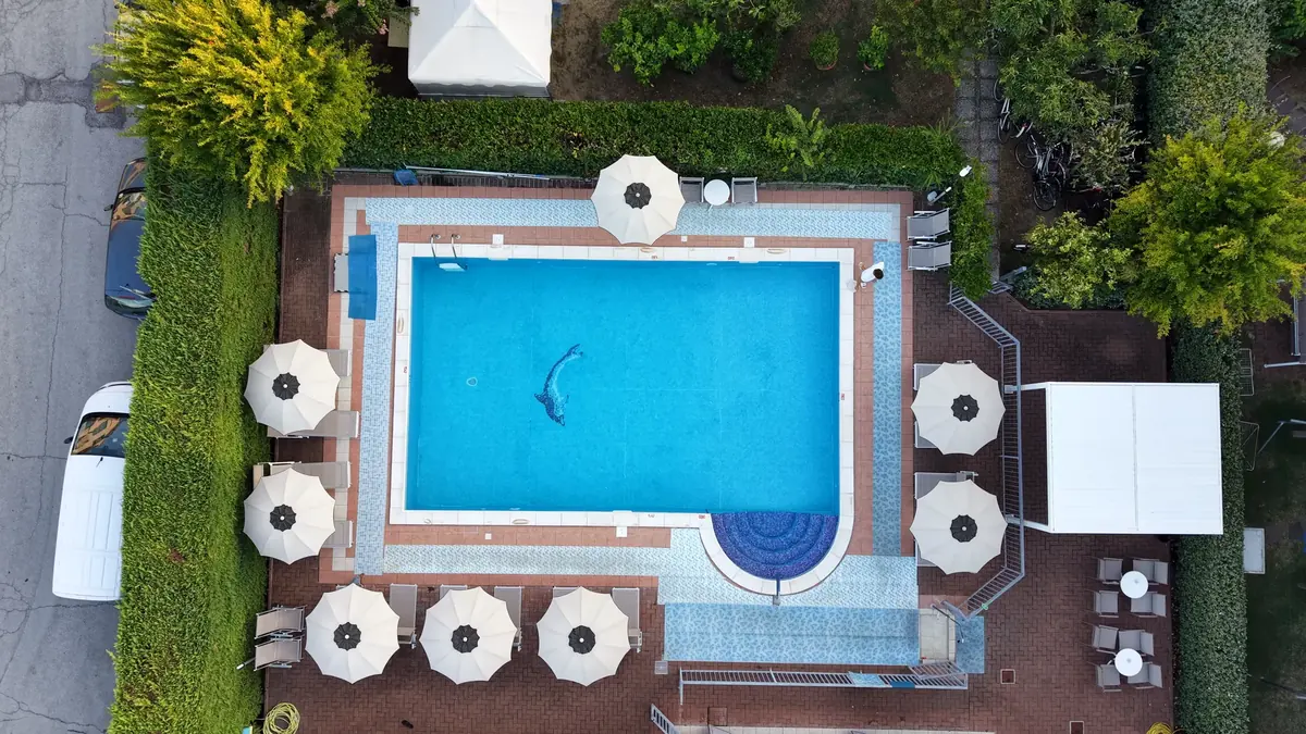 The residence pool from above, with umbrellas around it